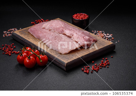 A piece of fresh juicy raw pork with salt, spices and herbs 106535374