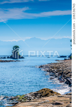 The view from Amaharashi Coast, a tourist destination representing Toyama with refreshing blue skies and calm waves, towards the Tateyama Mountain Range | Takaoka City, Toyama Prefecture 106536743