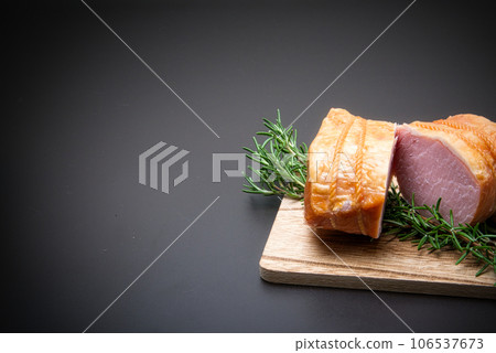 Place the chunks of ham on the cutting board. 106537673
