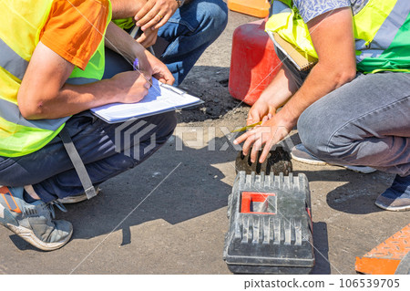 Road engineers measure the thickness of the laid asphalt and record the data in a spreadsheet. Road engineers measure the thickness of the laid asphalt and record the data in a spreadsheet. 106539705