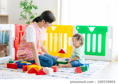 Nursery teacher and children playing with toys 106539904