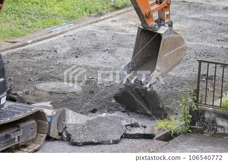Excavator removing old asphalt for paving work 106540772