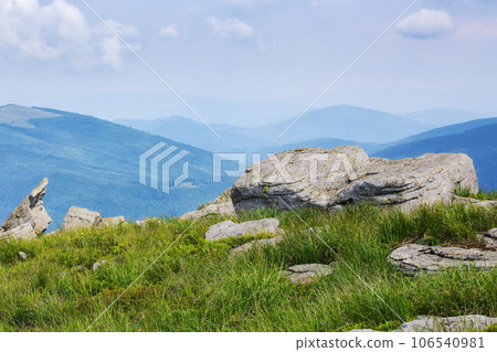 boulders on the grassy hill. mountainous summer landscape. clouds on the blue sky boulders on the grassy hill. mountainous summer landscape. clouds on the blue sky 106540981