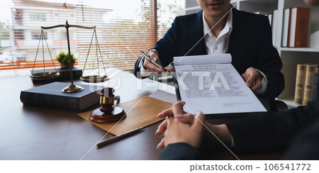 Home loan insurance, Male lawyer or judge Consult with client and working with report the case on table in office, Law and justice concept Home loan insurance, Male lawyer or judge Consult with client and working with report the case on table in office, Law and justice concept 106541772