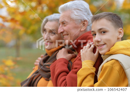 elderly couple and grandson playing in autumn park 106542407