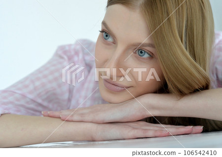 Beauty portrait. Young woman on grey wall background. 106542410