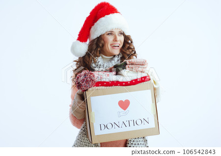 cheerful woman in sweater, mittens, hat and scarf on 106542843