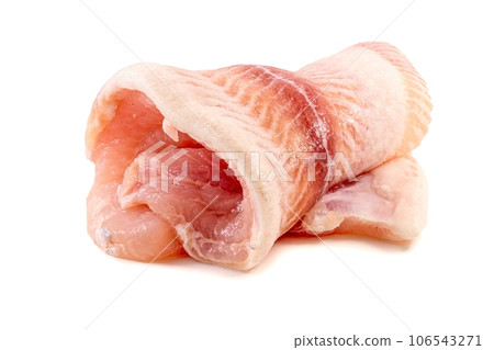 Pangasius known as iridescent shark catfish fillet. Fillet of Fish Pangasius. Isolated on white background. Fresh Fish Filet roll 106543271