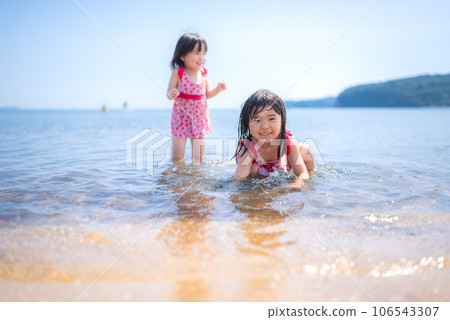 sisters playing on the summer beach sisters playing on the summer beach 106543307