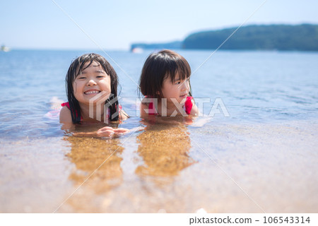 sisters playing on the summer beach sisters playing on the summer beach 106543314