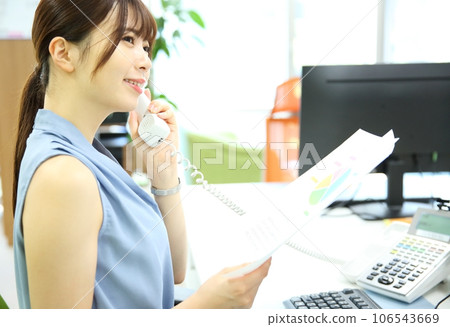 Image of a young female employee on the phone 106543669