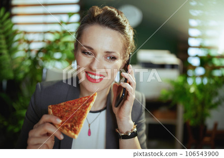 smiling business owner woman in green office talking on phone smiling business owner woman in green office talking on phone 106543900