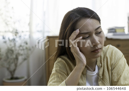 woman hand touching head have headache, young asian female stressed from hard work. woman hand touching head have headache, young asian female stressed from hard work. 106544648
