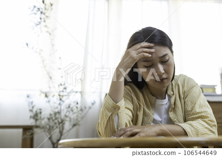 woman hand touching head have headache, young asian female stressed from hard work woman hand touching head have headache, young asian female stressed from hard work 106544649