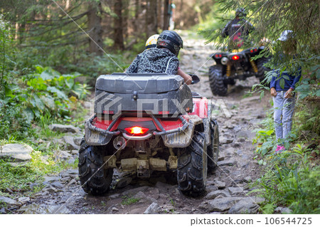 ATV on the mountain road in forest causing erosion problem for environment ATV on the mountain road in forest causing erosion problem for environment 106544725