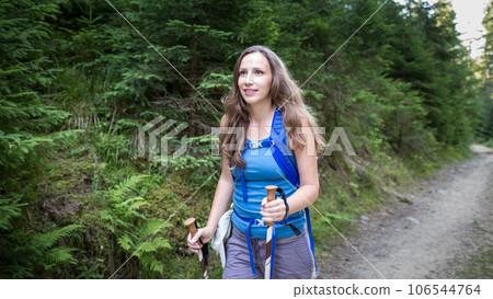 Young woman hiking through the forest in mountains Young woman hiking through the forest in mountains 106544764