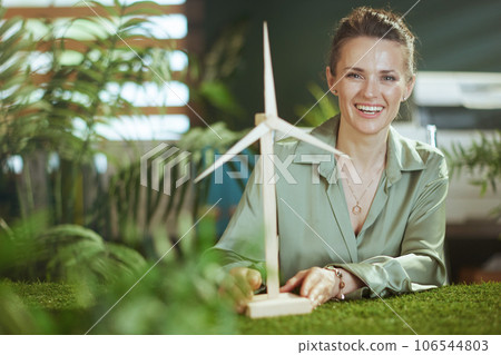 happy business owner woman in green blouse in green office happy business owner woman in green blouse in green office 106544803