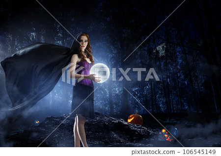 Beautiful young woman in witches hat and costume 106545149