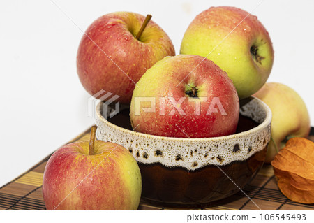 Ruddy ripe red apples in a bowl on the table 106545493