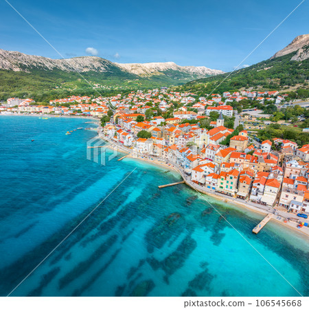 Aerial view of buildings with orange roofs, beach, mountains, sea Aerial view of buildings with orange roofs, beach, mountains, sea 106545668