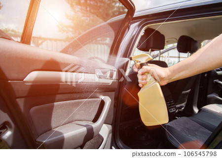 Care and cleaning of the plastic interior of the car with a cleaner and polish. Copy space for text 106545798