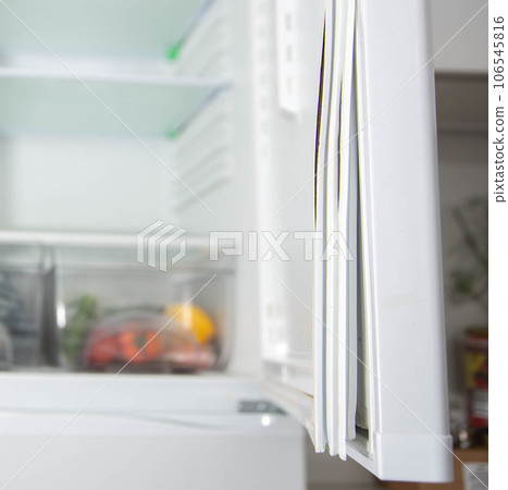 Torn and damaged sealing gum on the refrigerator door. Replacing the old sealing rubber with a new one Torn and damaged sealing gum on the refrigerator door. Replacing the old sealing rubber with a new one 106545816