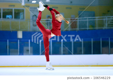 Talented, flexible girl in motion, figure skating athlete in red sportswear training on ice rink arena. Championship preparation Talented, flexible girl in motion, figure skating athlete in red sportswear training on ice rink arena. Championship preparation 106546229