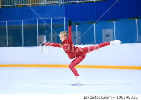 Talented, hardworking and concentrated girl, figure skating athlete in motions, training on ice rink arena 106546316