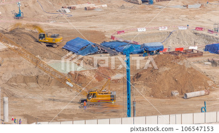Pile driving in foundation pit for construction of apartment complex building aerial timelapse in UAE 106547153