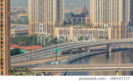 Walking promenade along water canal in Business Bay district of Dubai aerial timelapse. Walking promenade along water canal in Business Bay district of Dubai aerial timelapse. 106547157