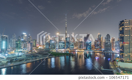Aerial view to Dubai Business Bay and Downtown with the various skyscrapers and towers night timelapse 106547171