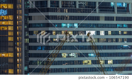 Office and residential buildings windows illuminated at night timelapse 106547190