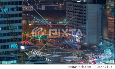 Skyscrapers and traffic on crossroad near Business Bay Metro Station alongside Sheikh Zayed Road in Dubai night timelapse. 106547193