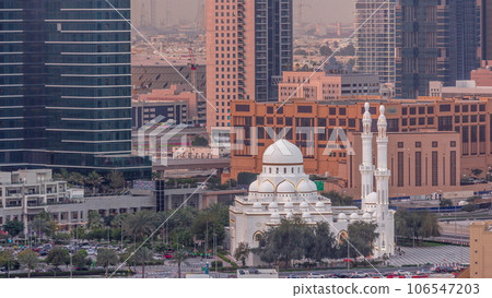 New white mosque near bay avenue surrounded by skyscrapers in Business Bay district aerial timelapse. 106547203