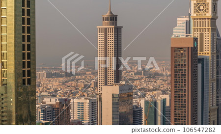 Skyline view of the high-rise buildings along Sheikh Zayed Road in Dubai aerial timelapse, UAE. Skyline view of the high-rise buildings along Sheikh Zayed Road in Dubai aerial timelapse, UAE. 106547282