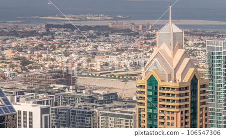 City walk houses and villas. Buildings on Sheikh Zayed Road in Dubai aerial timelapse, UAE. City walk houses and villas. Buildings on Sheikh Zayed Road in Dubai aerial timelapse, UAE. 106547306