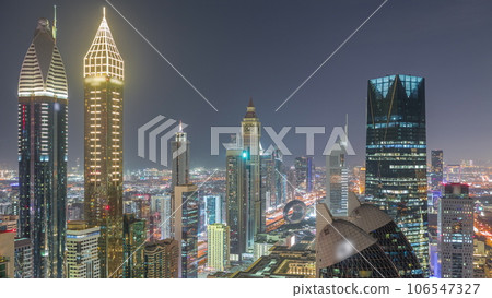 Skyline view of the high-rise buildings on Sheikh Zayed Road in Dubai aerial night timelapse, UAE. 106547327