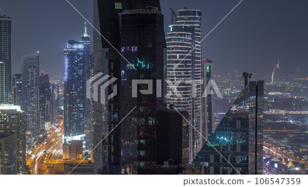 High-rise buildings on Sheikh Zayed Road in Dubai aerial night timelapse, UAE. 106547359
