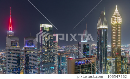 Skyline view of the high-rise buildings on Sheikh Zayed Road in Dubai aerial night timelapse, UAE. 106547362