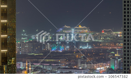 Aerial view of apartment houses and villas in Dubai city near downtown night timelapse. Aerial view of apartment houses and villas in Dubai city near downtown night timelapse. 106547382