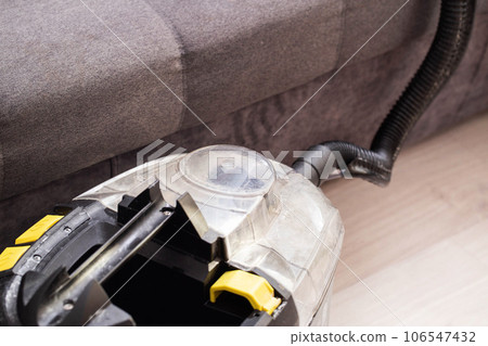 Modern professional washing vacuum cleaner for upholstered furniture on a black background. The concept of dry cleaners at home. Copy space for text 106547432