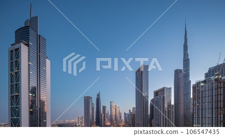 Aerial sunrise view of Dubai Downtown skyline with many towers night to day timelapse. Aerial sunrise view of Dubai Downtown skyline with many towers night to day timelapse. 106547435