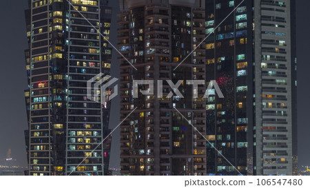 Tall blocks of flats with glowing windows located in residential district of city aerial timelapse. Tall blocks of flats with glowing windows located in residential district of city aerial timelapse. 106547480