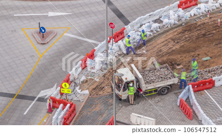 Process of sidewalk road repairing with many builder workers and equipment aerial timelapse in Dubai Process of sidewalk road repairing with many builder workers and equipment aerial timelapse in Dubai 106547512