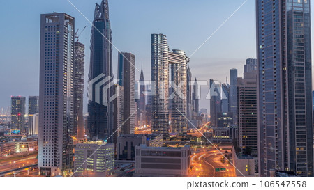 Many towers and skyscrapers with traffic on streets in Dubai Downtown and financial district night to day timelapse. Many towers and skyscrapers with traffic on streets in Dubai Downtown and financial district night to day timelapse. 106547558