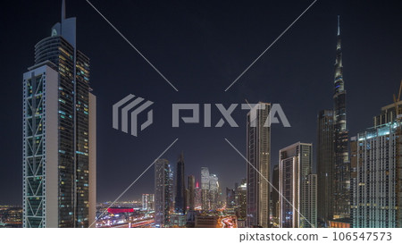 Aerial view of Dubai Downtown skyline with many towers night timelapse. Aerial view of Dubai Downtown skyline with many towers night timelapse. 106547573