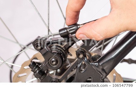 Adjusting the tension of the bicycle brake caliper cable. Brake setting. Copy space for text. Close-up 106547799