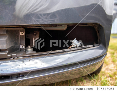Removed fog lamp from a car to replace a burnt out light bulb. Close-up 106547963