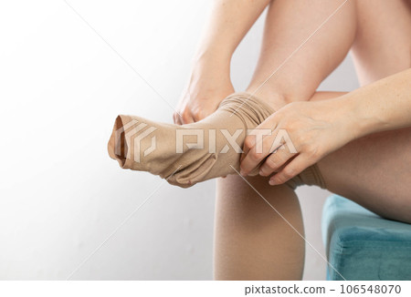 A Woman Puts A Compression Stocking On Her Leg With Varicose Veins Varicose  Veins Prevention Compression Tights Relief For Tired Legs Female Legs In  Stockings Stock Photo - Download Image Now - iStock