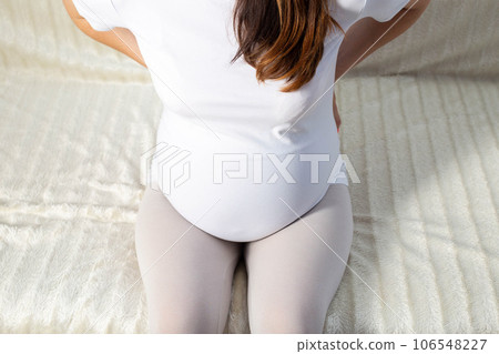Lower back pain in a pregnant woman. Exacerbation of chronic diseases, osteochondrosis and intervertebral hernia. Load on the spine, change in posture in pregnant women. Close-up 106548227